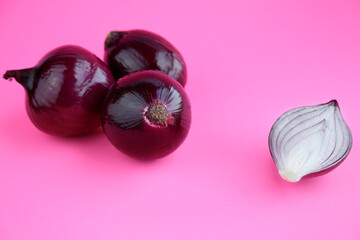 Red onions isolated on pink background