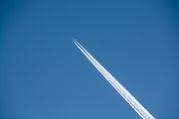 冬の寒い朝の青空の飛行機雲