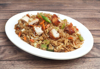 Indian cuisine Healthy and tasty chicken fried rice served in white bowl over a rustic wooden background, selective focus