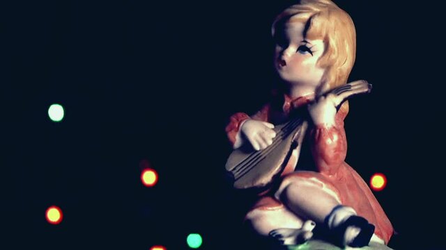 Natale vintage, bambola bambina che suona con luci a intermittenza colorate.