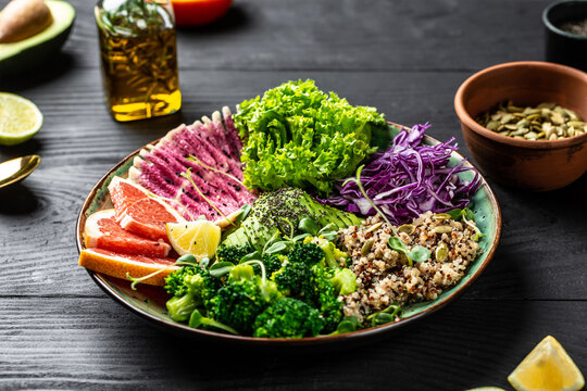 Vegetarian Menu, Healthy Food. Healthy Salad With Quinoa, Micro Greens, Avocado, Grapefruit, Broccoli, Watermelon Radish, Red Cabbage