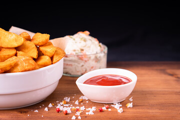 Tradition french fries from organic bio potato wedges with skin dip in ketchup