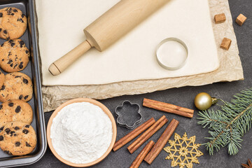 Preparing Christmas treat. Rolling pin for dough. Cookie cutter molds. Ready-made cookies