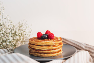 Homemade tasty pancakes for breakfast. Decorated with berries. Healthy eating concept.