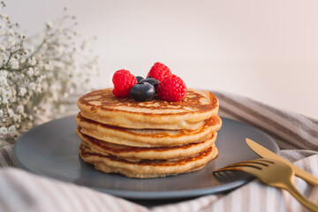 Homemade tasty pancakes for breakfast. Decorated with berries. Healthy eating concept.