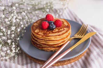 Homemade tasty pancakes for breakfast. Decorated with berries. Healthy eating concept.