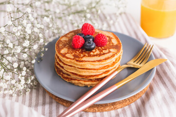 Homemade tasty pancakes for breakfast. Decorated with berries. Healthy eating concept.