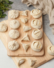 Prepared semi-finished products. Dumplings, khinkali, manti. New year's atmosphere