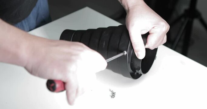 Worker unscrew the screws from the metal