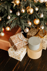 Beautiful  boxes with gifts under the Christmas tree. New year and Christmas holidays concept.