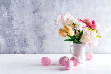 Easter greeting card backdrop with colorful spring flowers on white background. With copy space