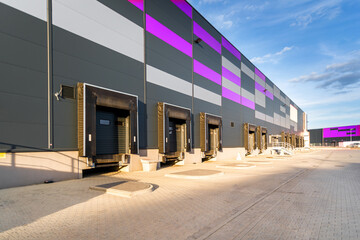 Cargo loading dock doors of big warehouse building, outdoor