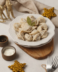 Prepared semi-finished products. Dumplings, khinkali, manti. New year's atmosphere