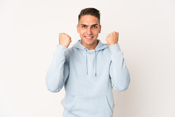 Young caucasian handsome man isolated cheering carefree and excited. Victory concept.