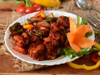Delicious spicy prawns chilli masala or shrimp curry cooked in south indian style.. served over a rustic wooden background, selective focus