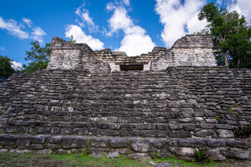 Kinichna pyramid. Mayan archeological site. Trees on stairs