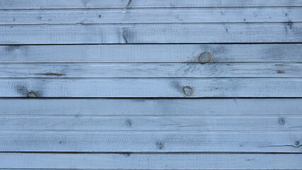 Fototapeta premium knotted textured wooden background from horizontal narrow planks with unique cutaway wood pattern, exterior and interior natural light wood background, empty embossed surface in rustic style