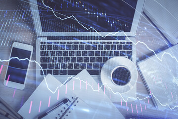 Stock market chart and top view computer on the table background. Double exposure. Concept of financial analysis.