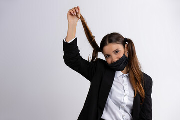 Beautiful girl in medical mask posing on a white background. New normal concept.