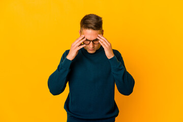 Young handsome caucasian man isolated touching temples and having headache.