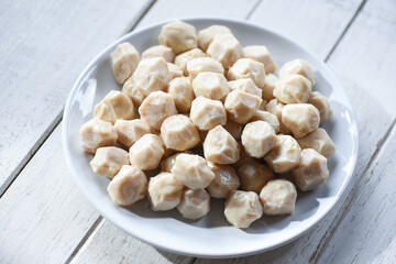 Meat ball on white plate and wooden background, meat ball with pork and ingredient for cooked asian thai food.