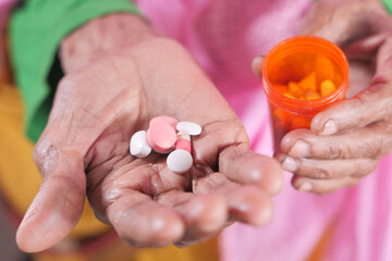  senior women hand's taking medicine, close up 