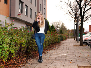 Young woman talking and communicating through her mobile phone