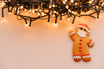 New Year and Christmas celebration in a coronavirus pandemic, conceptual background with ginger man...