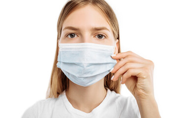 Young woman in protective mask, on an isolated white background. Influenza, allergies, virus protection, coronavirus pandemic