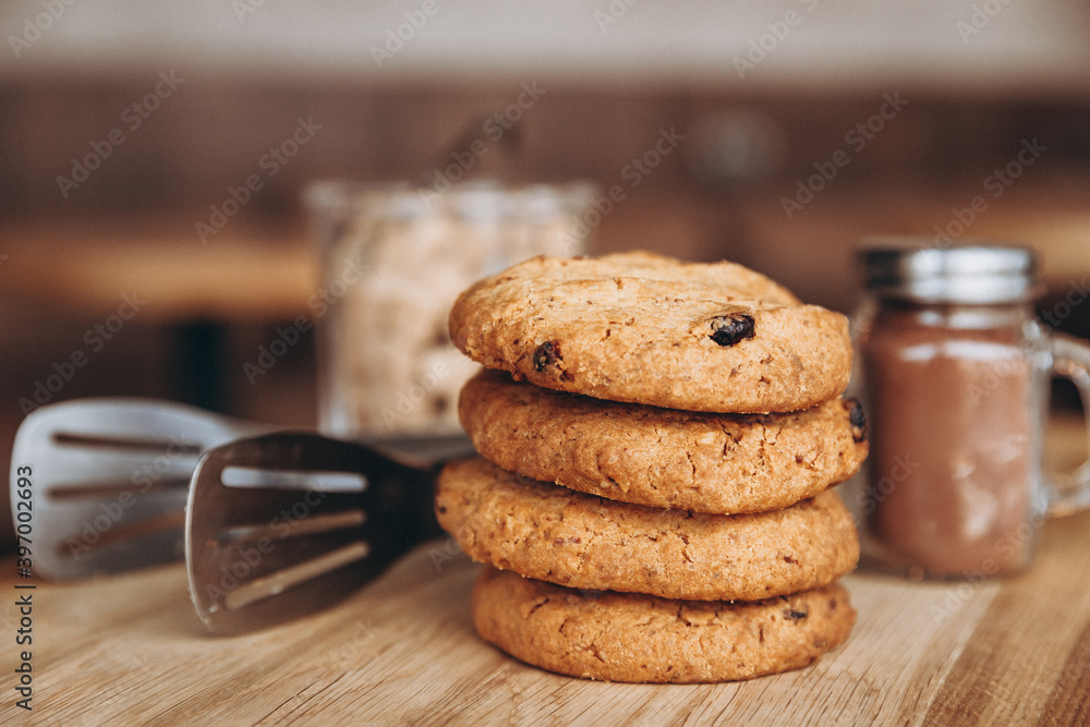 Wall mural close up photo of delicious and crunchy oatmeal cookies on the backdrop of a cozy restaurant or bakery interior, festive Christmas mood, 4 cookies lying on top of each other