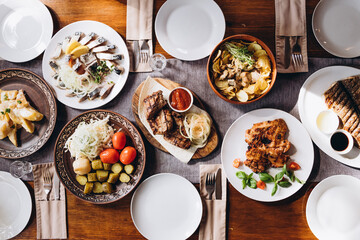 The restaurant table with Ukrainian and European cuisine is served with various delicious dishes for the reception