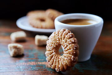 Butter cookie and a cup of Coffee  on rustic wooden background. Close up.