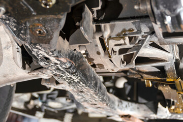 Engine oil falls from a broken engine barrel.