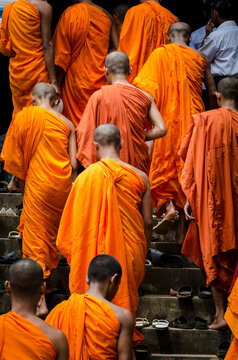 MONKS, KAMPOT, CAMBODIA - 27 September 2011: Monks leave shoes on steps before entering dinning hall for lunch time meal in local pagoda.