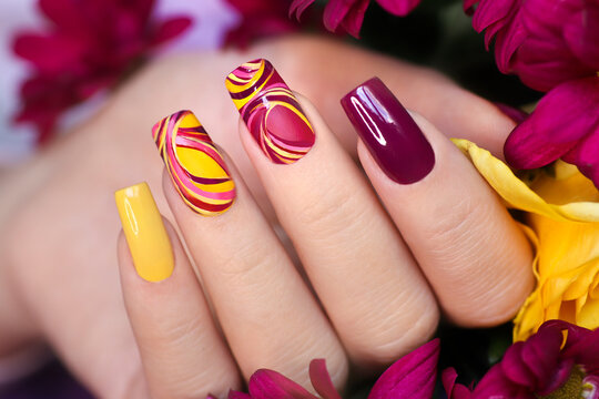 Nail design on shiny and matte nail Polish with smooth curves.Fashionable multicolored manicure.