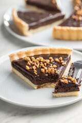 Sweet chocolate pie with crushed nuts.