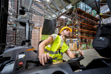 Warehouse worker in a forklift truck places the packages on the shelves