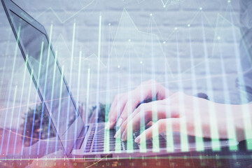 Multi exposure of woman hands typing on computer and forex chart hologram drawing. Stock market...