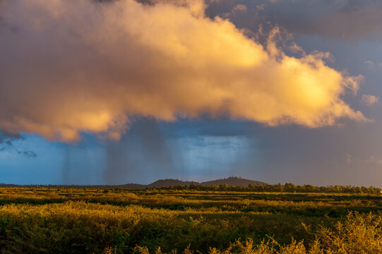 SUNSET, UDONG, CAMBODIA - 15 July 2012: Udong mountain littered with temples in dramatic sunset with rain clouds in the sky.