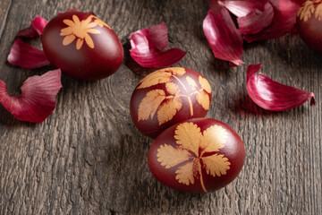 Easter eggs dyed with onion peels on a table, close up