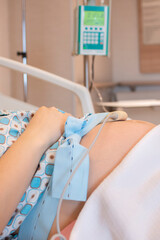 Pregnant woman in newborn hospital lying near fetal heart beat by fetal monitoring with Non stress...
