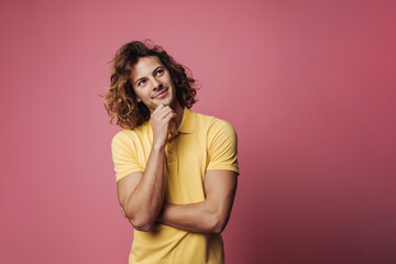 Happy handsome unshaven guy smiling and looking upward