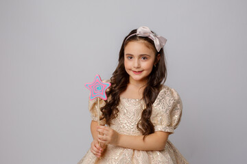 little girl in the image of a fairy with a magic wand on a white background