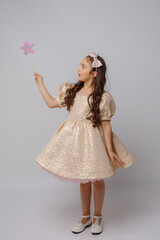 little girl in the image of a fairy with a magic wand on a white background