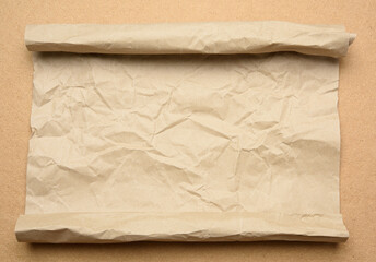 roll of brown parchment paper on a brown backgr