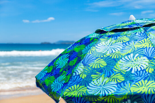 Close up of parasol in a tropical beach of Brazil. Summer vacation concept. Image for travel websites.