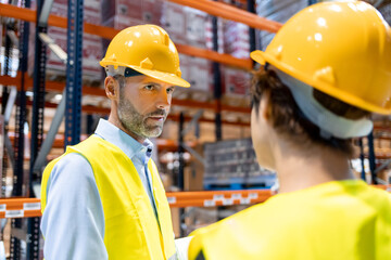 Warehouse workers consult delivery plans