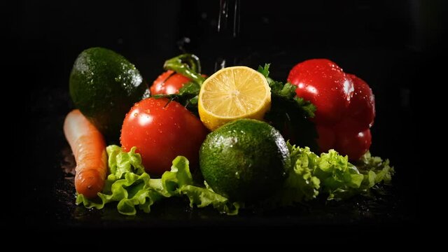 Water Jet Falling on Fresh Vegetables and Fruits by the Black Background. Slow Motion. Healthy Lifestyle, Vegetarian Food and Dieting Concept