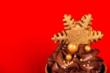 Chocolate cupcakes with star-shaped cookies on a red background. Christmas mood. Sweets for any occasion