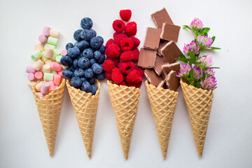 berries, chocolate and flowers in waffle cones